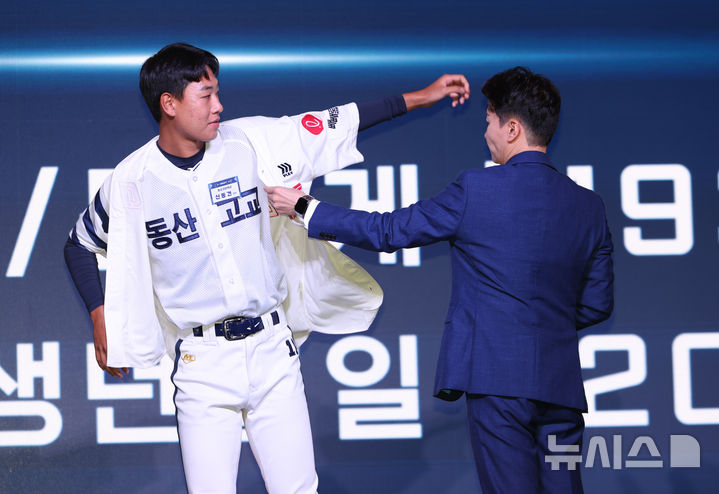 [서울=뉴시스] 황준선 기자 = 17일 오후 서울 송파구 롯데호텔월드에서 열린 2026 KBO 신인 드래프트에서 롯데 자이언츠 1라운드 지명된 동산고 신동건이 구단 유니폼을 입고 있다. 2025.09.17. hwang@newsis.com