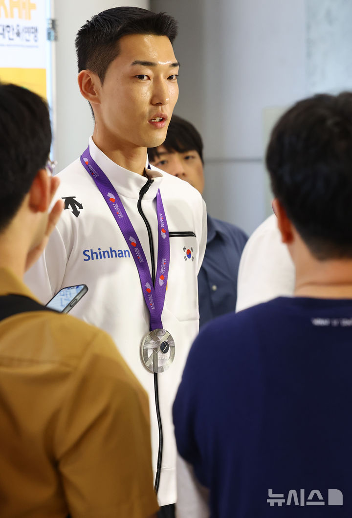 [서울=뉴시스] 박주성 기자 = 2025 도쿄 세계육상선수권대회 남자 높이뛰기에서 은메달을 획득한 우상혁 션수가 18일 서울 강서구 김포국제공항 입국장으로 귀국해 취재진의 질문에 답하고 있다. 2025.09.18. park7691@newsis.com