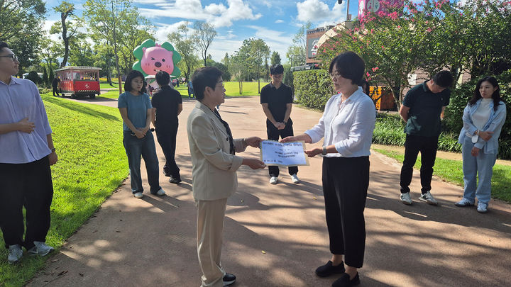 [여수=뉴시스] 백인숙(왼쪽) 여수시의회 의장이 26일 '여수MBC 순천이전 협약식이 열리는 순천만국가정원 정원워케이션 앞에서 항의 서한을 순천시관계자에게 전달하고 있다.&nbsp; (사진=여수시 제공) 2025.09.26. photo@newsis.com&nbsp; *재판매 및 DB 금지