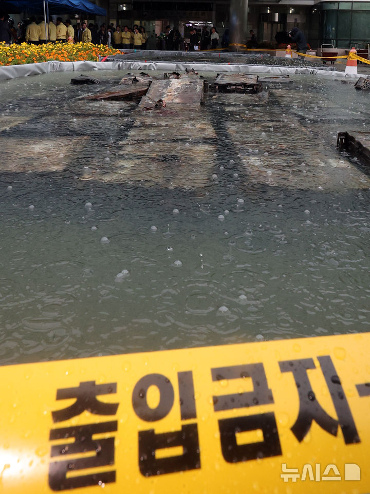 [대전=뉴시스] 강종민 기자 = 28일 화재가 완진된 대전 유성구 국가정보자원관리원. 외부 침수조에 냉각작업 중인 리튬이온 배터리 위로 빗방울이 떨어지고 있다. 2025.09.28. ppkjm@newsis.com