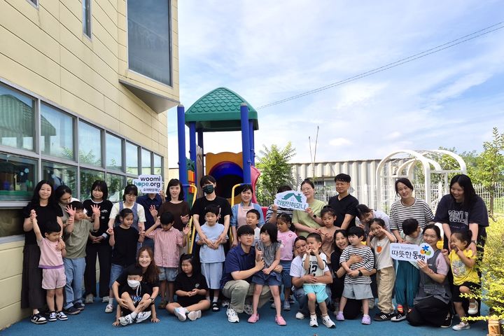 [서울=뉴시스] 구미 하늘어린이집 원아와 교사가 ‘2025 리빙인하모니’를 통해 개선된 외부놀이공간에 모여 있다. (사진=우미건설 제공) 2025.09.29. photo@newsis.com *재판매 및 DB 금지