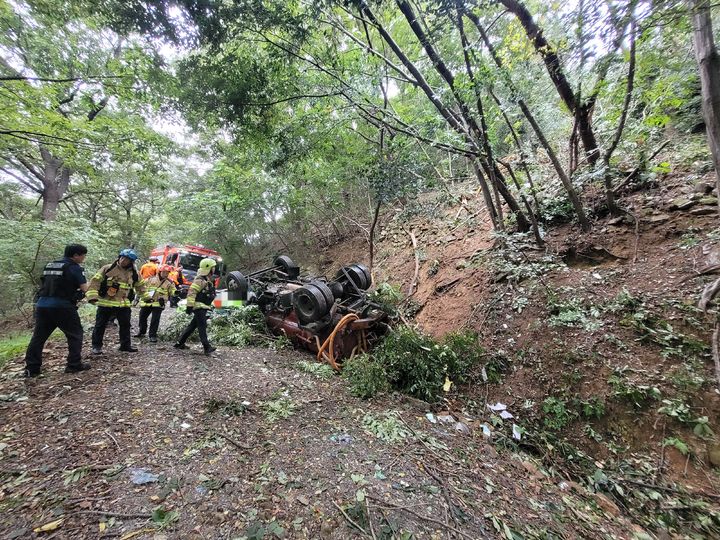 [양산=뉴시스] 양산시 호계동 천성산의 한 임도를 내려오던 4t급 분뇨 수거차가 약 70m 아래로 추락, 경찰과 119 구조대가 구조하고 있다. (사진=독자 제공) 2025.09.29. photo@newsis.com *재판매 및 DB 금지