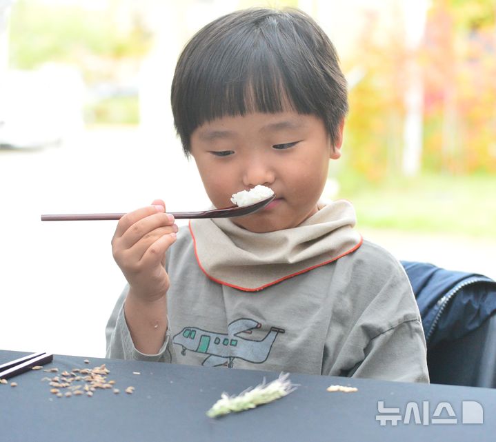 [청주=뉴시스] 서주영 기자 = 3일 충북 청주 동부창고에서 열린 강진주 작가·선재스님의 예술 퍼포먼스 '쌀의 순환-생명의 순환을 담은 한 그릇의 여정'에 참가한 어린이가 토종쌀로 지은 밥의 냄새를 맡고 있다. 2025.10.03. juyeong@newsis.com 
