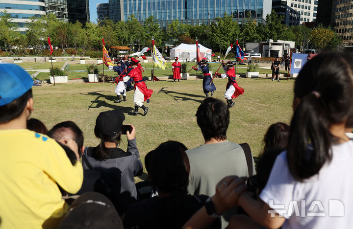 [서울=뉴시스] 조성우 기자 = 8일 오후 서울 종로구 의정부지 역사유적광장에서 시민들이 전통 무예 시연을 관람하고 있다. 2025.10.08. xconfind@newsis.com