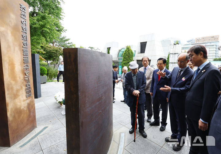 [서울=뉴시스] 최진석 기자 = 최휘영(오른쪽) 문화체육관광부 장관이 579돌 한글날인 9일 오전 서울 광화문광장 인근 조선어학회한말글수호기념탑을 찾아 설명을 듣고 있다. 2025.10.09. myjs@newsis.com