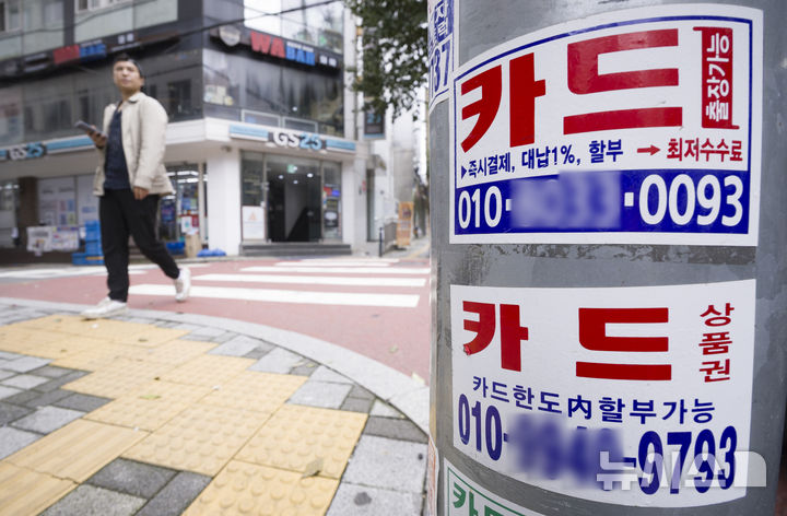 [서울=뉴시스] 김근수 기자 = 지난 12일 서울 시내의 한 음식점 거리에 놓인 가로등에 카드 대출 안내문이 붙어 있다. 2025.10.13. ks@newsis.com