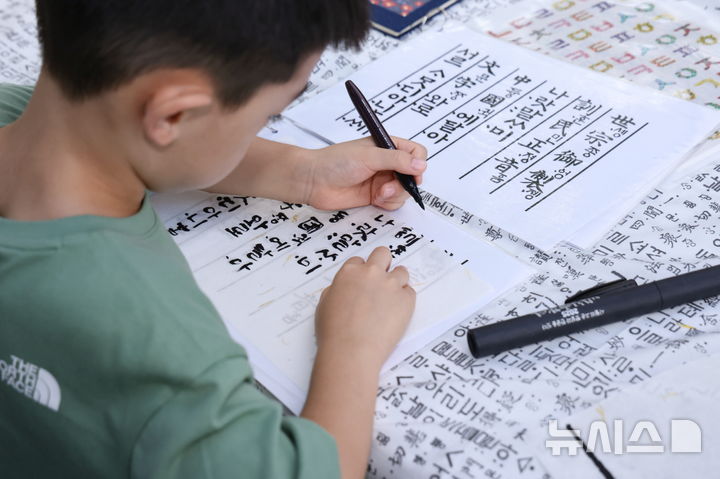 [의왕=뉴시스] '제12회 의왕한글한마당'에 참석한 한 어린이가 훈민정음 필사본을 옮겨 쓰고 있다. (사진=의왕시 제공).2025.10.13.photo@newsis.com
