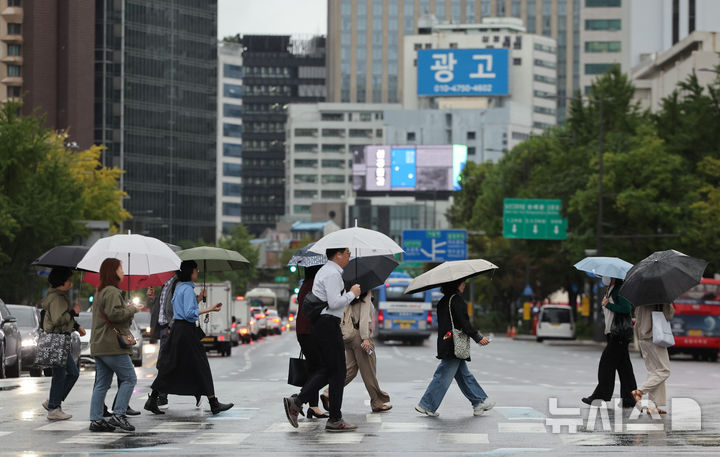 [서울=뉴시스] 황준선 기자 = 전국 대부분 지역에 비가 내린 13일 서울 종로구 세종대로 사거리에서 우산을 쓴 시민들이 발걸음을 옮기고 있다. 2025.10.13. hwang@newsis.com