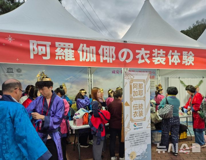 [함안=뉴시스]경남도와 경남관광재단이 지난 16일 함안군 무인정에서 진행한 외국인 대상 낙화놀이 특별행사에 온 일본인 관광객들이 함안 아라가야 전통의상 체험 부스에 환복하고 있다.(사진=경남도 제공) 2025.10.17. photo@newsis.com