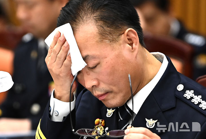 [수원=뉴시스] 김종택 기자 = 황창선 경기남부경찰청장이 21일 경기 수원시 경기남부경찰청에서 열린 국회 행정안전위원회 경기남·북부 경찰청에 대한 국정감사에서 땀을 닦고 있다. 2025.10.21. jtk@newsis.com
