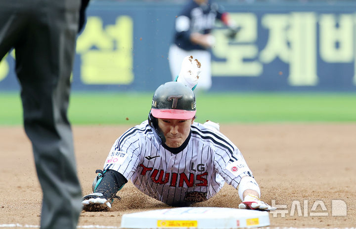 [서울=뉴시스] 이영환 기자 = 26일 오후 서울 송파구 잠실야구장에서 열린 2025 KBO 한국시리즈 1차전 한화 이글스와 LG 트윈스의 경기, 5회말 1사에서 LG 신민재가 3루타를 날린 후 베이스에 슬라이딩 하고 있다. 2025.10.26. 20hwan@newsis.com