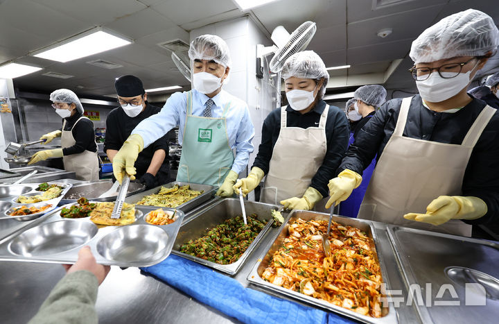 [서울=뉴시스] 최진석 기자= 염영남(가운데) 뉴시스 대표이사와 임직원들로 구성된 자원봉사단이 27일 서울 용산구 갈월동 서울특별시립 다시서기종합지원센터를 찾아 점심 배심 봉사를 하고 있다. 2025.10.27. myjs@newsis.com