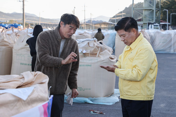 [고성(경남)=뉴시스] 신정철 기자= 경남 고성군은 농업인의 안정적인 소득 보장과 쌀 수급 안정을 위해 28일, 가루쌀 매입을 시작으로 오는 12월 10일까지 공공비축미 7544t(포대벼 기준 18만8613포대/40㎏)를 매입한다. 사진은 이상근 고성군수(사진, 오른쪽)가 28일 공공비축미 매입현장을 살펴보고 있다.(사진=고성군 제공).2025.10.28. photo@newsis.com *재판매 및 DB 금지