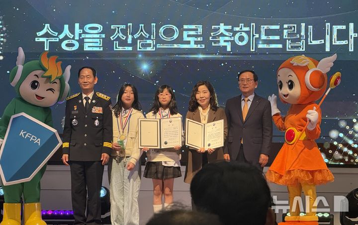 [창원=뉴시스]지난달 30일 서울 여의도 한국화재보험협회 강당에서 소방청과 한국화재보험협회 공동 주최로 열린 제25회 전국 불조심 어린이마당 학습평가 시상식에서 경남 대표로 참가한 김해 율하초등학교 5학년 6반 학급 대표 학생과 이선화 지도교사가 1위인 대상을 수상한 후 기념촬영하고 있다.(사진=경남소방본부 제공) 2025.11.01. photo@newsis.com