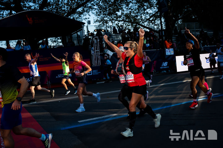 [뉴욕=AP/뉴시스] 2일(현지 시간) 미국 뉴욕에서 열린 2025 뉴욕 마라톤 대회에서 참가자들이 결승선을 통과하고 있다. 2025.11.03.