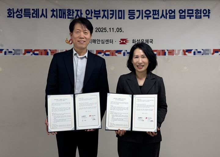 [화성=뉴시스]곽매헌 화성시서부보건소장(사진 오른쪽)과 정영한 화성우체국장이 5일 치매환자 안부지키미 등기우편사업 업무협약을 체결하고 기념촬영하고 있다.(사진=화성시 제공02025.11.06.photo@newsis.com *재판매 및 DB 금지