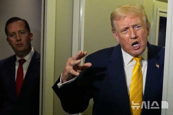 [AP/뉴시스] 미 트럼프 대통령이 14일 플로리다주 마러라고 저택으로 가던 에어포스원에서 기자들에게 말하고 있다. 옆에 세르지오 고르 주인도 미국 대사가 듣고 있다. 