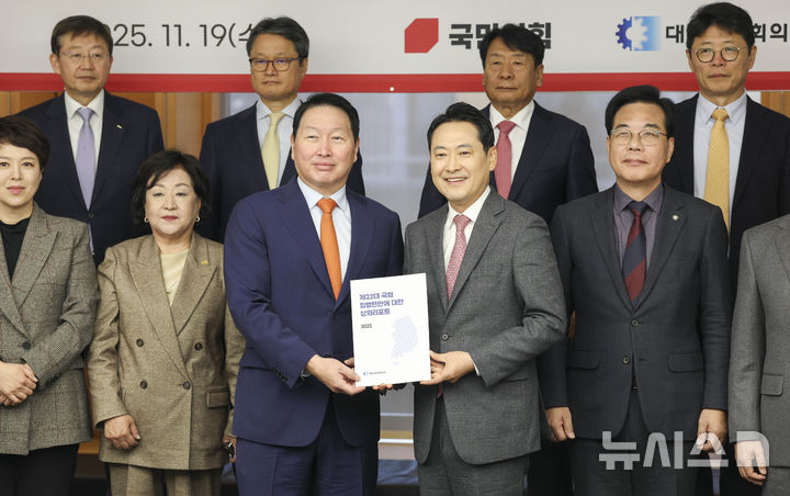 [서울=뉴시스] 홍효식 기자 = 최태원 대한상공회의소 회장이 19일 서울 중구 대한상공회의소에서 열린 국민의힘-대한상공회의소 정책 간담회에서 장동혁 국민의힘 대표에게 정책 제안서를 전달하고 있다. (공동취재) 2025.11.19. photo@newsis.com