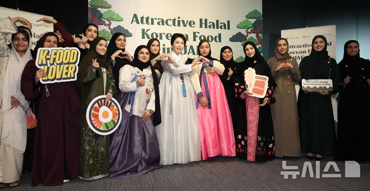 [아부다비=뉴시스] 최동준 기자 = 김혜경 여사가 19일(현지 시간) 아부다비 주UAE한국문화원에서 열린 할랄 K-푸드 홍보행사에서 참석자들과 기념촬영을 하고 있다. 2025.11.19. photocdj@newsis.com