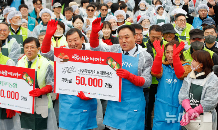 [제주=뉴시스] 우장호 기자 = 제주도개발공사 임직원들이 20일 오전 제주시 애월읍 렛츠런파크 제주에서 열린 '2025 행복한 나눔 제주 김장축제' 행사에 참여해 인사하고 있다.올해 김장 나눔량은 총 1만 포기, 약 3만㎏ 규모다. 완성된 김장김치는 도내 저소득 아동가정, 장애인시설, 독거어르신, 범죄피해가정 등 5300가구(약 1만6000명)에게 전달될 예정이다. 2025.11.20. woo1223@newsis.com