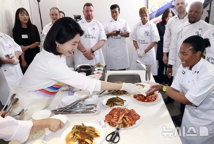 [요하네스버그=뉴시스] 최동준 기자 = 이재명 대통령과 함께 남아프리카공화국을 방문 중인 김혜경 여사가 22일(현지 시간) 요하네스버그 주남아공한국문화원에서 열린 한-남아공 음식문화 만남 및 문화원 학생 격려 행사에서 참석자들에게 된장찌개, 불고기, 김치를 나눠주며 한국 음식에 대해 설명하고 있다. 2025.11.22. photocdj@newsis.com