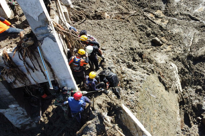 [파당판장=AP/뉴시스] 1일(현지 시간) 인도네시아 서수마트라주 파당판장에서 구조대가 홍수 희생자 시신을 수습하고 있다. 2025.12.01.