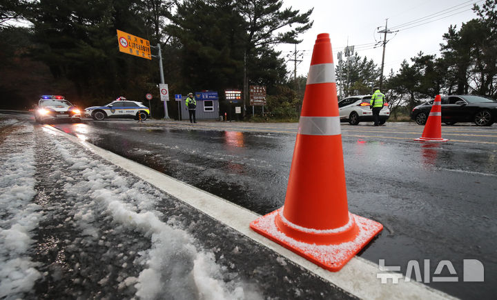 [제주=뉴시스] 우장호 기자 = 제주 산간에 대설특보가 내려진 3일 오전 제주시 1100도로 초입부인 어승생 삼거리에서 제주서부경찰서 소속 경찰관들이 교통 통제를 하고 있다. 2025.12.03. woo1223@newsis.com