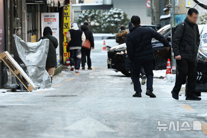[서울=뉴시스] 권창회 기자 = 폭설 후 한파로 도로 곳곳이 얼어붙은 5일 오전 서울 중구 충무로역 인근에서 시민들이 빙판길을 조심히 걷고 있다. 2025.12.05. kch0523@newsis.com
