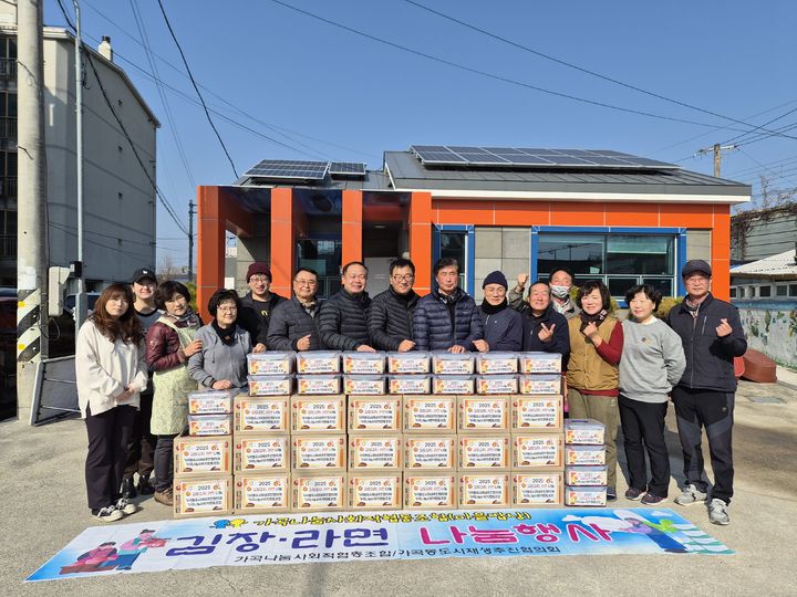 [밀양=뉴시스] 경남 밀양시 가곡동 도시재생 거버넌스 조직이 김장김치·라면 나눔 행사에 이어 기념촬영을 하고 있다. (사진=밀양시 제공) 2025.12.08. photo@newsis.com *재판매 및 DB 금지