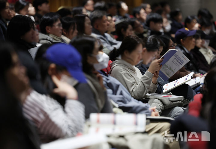 [서울=뉴시스] 김진아 기자 = 13일 서울 성북구 고려대학교 인촌기념관에서 열린 서울시교육청 교육연구정보원, 2026 대입 정시모집 대비 진학지도 설명회에서 학부모 등 참석자들이 자료를 살펴보고 있다. 2025.12.13. bluesoda@newsis.com