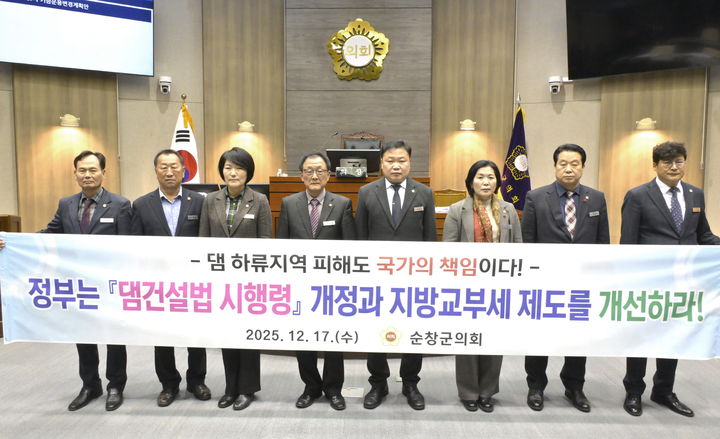 [순창=뉴시스] 17일 열린 순창군의회 제300회 임시회 제2차 본회의, 오수환 의원이 대표발의한 '댐 하류지역 지원사업 확대를 위한 댐건설법 시행령 개정 촉구 건의안'이 채택된 후 군의원들이 함께 현수막을 들고 건의내용 관철을 요구하고 있다. *재판매 및 DB 금지