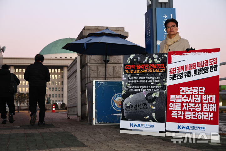 [서울=뉴시스] 김명년 기자 = 좌훈정 대한의사협회 부회장이 18일 오전 서울 여의도 국회 정문 앞에서 '건보 공단 특사경 권한 부여 저지를 위한 1인 시위'를 하고 있다. 2025.12.18. kmn@newsis.com