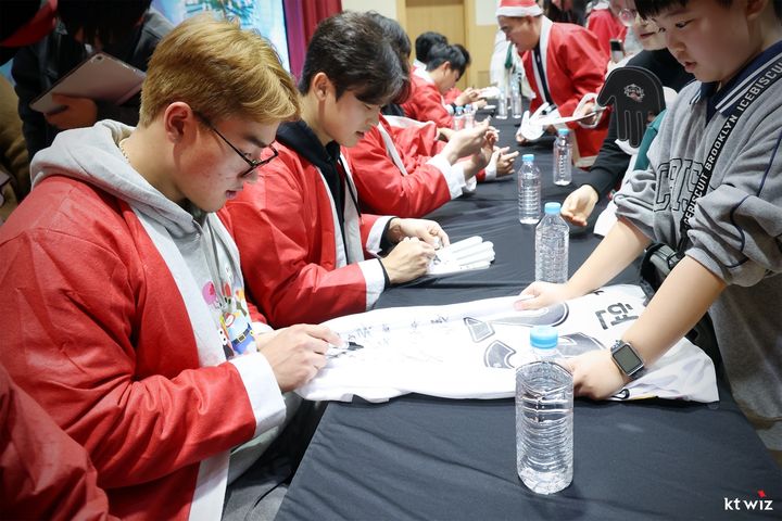 [서울=뉴시스] 프로야구 KT 위즈 선수단이 19일 수원특례시청에서 산타로 변신해 팬 사인회를 진행하고 있다. (사진=KT 위즈 제공) 2025.12.19. *재판매 및 DB 금지