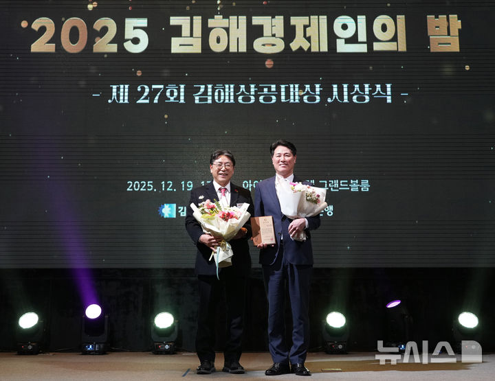 [김해=뉴시스]BNK경남은행 김태한(오른쪽) 은행장이 '2025 김해경제인의 밤 및 제27회 김해상공대상 시상식' 행사에서 홍태용 김해시장으로부터 감사패를 받고 있다.(사진=BNK경남은행 제공) 2025.12.22. photo@newsis.com