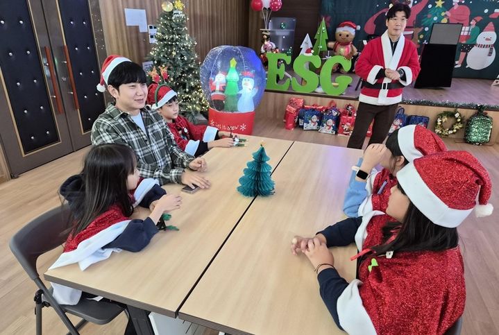 [서울=뉴시스] CJ올리브네트웍스 임직원이 지난 18일 효창종합사회복지관에서 열린 '크리스마스 파티'에 참석해 아이들과 함께 이야기를 나누고 있다. (사진=CJ올리브네트웍스 제공) *재판매 및 DB 금지