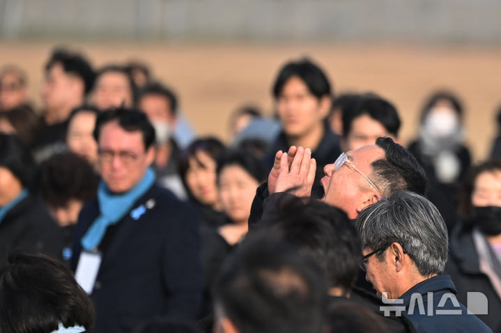 [무안=뉴시스] 이영주 기자 = 제주항공 여객기 참사 1주기인 29일 오후 전남 무안국제공항 활주로 콘크리트 둔덕 주변에서 한 참사 유가족이 희생자들을 기리며 하늘을 향해 소리치고 있다. 2025.12.29. leeyj2578@newsis.com