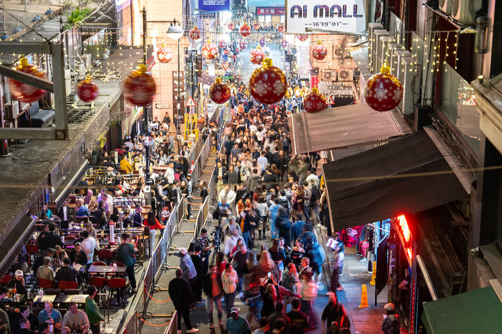 People gather at Lan Kwai Fong to celebrate the start of 2026 in the Central district of Hong Kong, Wednesday, Dec. 31, 2025. (AP Photo/Chan Long Hei)