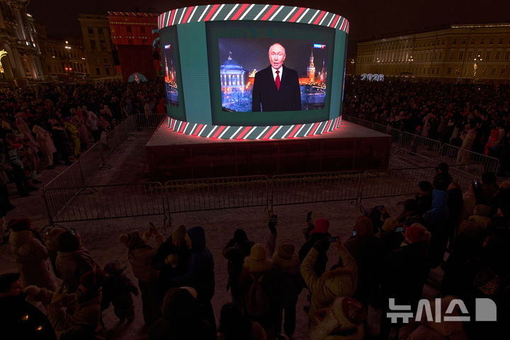 [상페테르부르크=AP/뉴시스] 지난달 31일 러시아 상페테르부르크 궁전 광장에서 시민들이 블라디미르 푸틴 러시아 대통령의 신년 메시지를 듣고 있다.2026.01.02. 