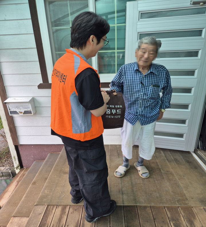 [태안=뉴시스] 태안지역자활센터 관계자가 지난 5일 태안 지역 내 저소득 보훈가족 어르신에게 직접 만든 밑반찬을 건네고 있다. (사진=태안군 제공) 2026.01.07. photo@newsis.com *재판매 및 DB 금지