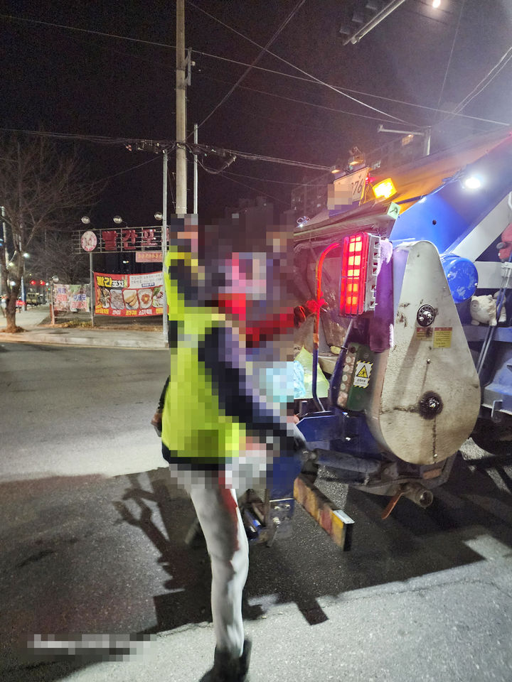 [밀양=뉴시스] 안지율 기자 = 지난 5일 경남 밀양시 신삼문동 빨간포차 앞 사거리 도로에서 환경미화원이 청소차량 뒤에 설치된 발판에 매달려 있다. 2026.01.07. alk9935@newsis.com *재판매 및 DB 금지