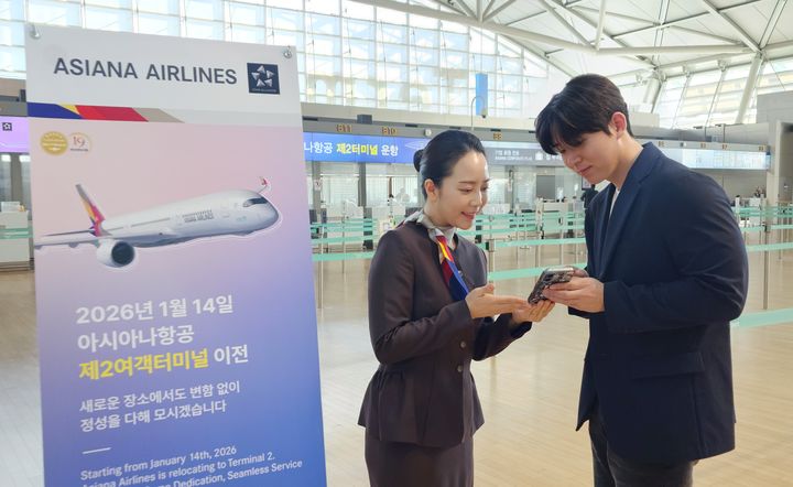 [서울=뉴시스] 아시아나항공이 오는 14일부터 인천공항 제2여객터미널에서 운항한다. 아시아나항공 직원이 승객에게 터미널 이전 안내를 하고 있다.(사진=아시아나항공 제공). 2026.01.07. photo@newsis.com *재판매 및 DB 금지