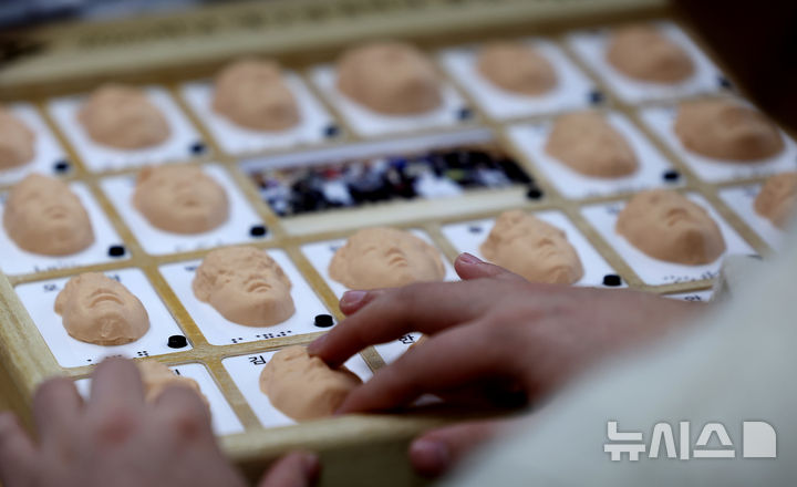 [대구=뉴시스] 이무열 기자 = 8일 대구 남구 시각장애 학생을 위한 교육기관인 대구광명학교에서 열린 2025학년도 졸업식에서 졸업생들이 3D 프린터로 제작된 졸업앨범 속 친구 얼굴을 손끝으로 만져보고 있다. 2026.01.08. lmy@newsis.com