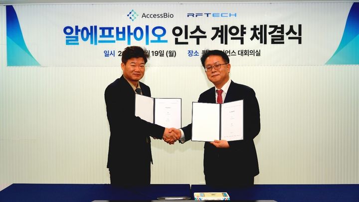[서울=뉴시스] 박희덕 팜젠사이언스 부회장 겸 엑세스바이오 이사(왼쪽), 윤정호 알에프텍 부사장이 19일 알에프바이오 인수 계약 체결식 기념촬영을 하고 있다. (사진=엑세스바이오 제공) 2026.1.19. photo@newsis.com *재판매 및 DB 금지