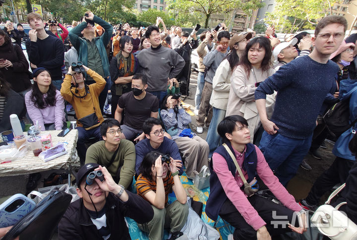 [타이베이=AP/뉴시스] 시민들이 25일(현지 시간) 대만 타이베이 초고층 빌딩 타이베이 101 인근에서 미국의 암벽 등반가 알렉스 호놀드의 등반 모습을 지켜보고 있다. 2026.01.26.