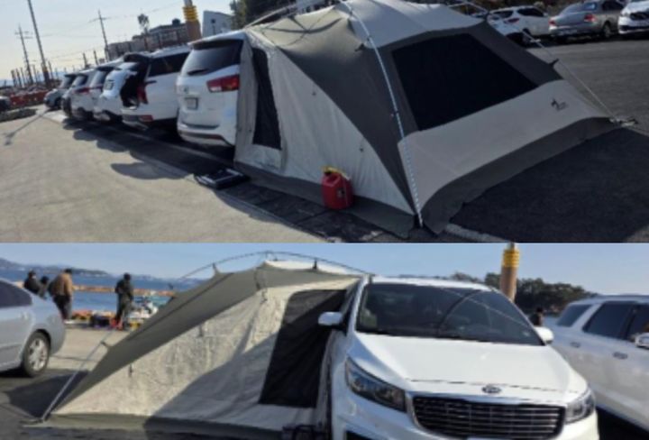국가 어항 공용주차장이 캠핑장인 것처럼 텐트를 설치하고, 그 텐트를 차에 연결까지 한 이른바 '주차장 캠핑족' 사연이 전해져 논란이 일고 있다.2026.02.03. (사진=보배드림 캡처) *재판매 및 DB 금지
