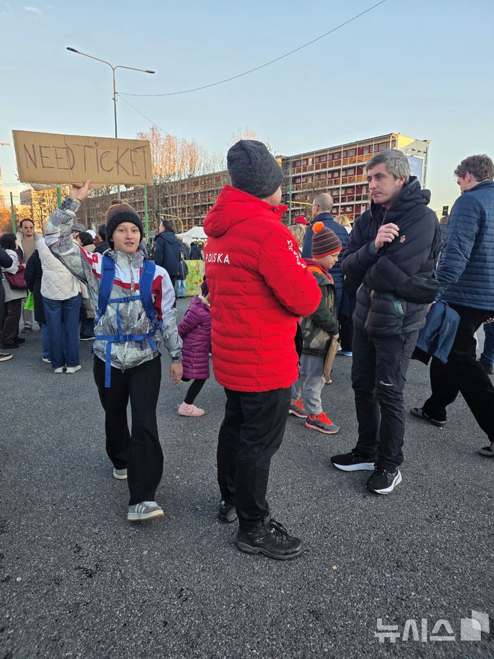 [밀라노=뉴시스] 김희준 기자 = 2026 밀라노·코르티나담페초 동계올림픽 개회식이 열리는 6일(현지 시간) 이탈리아 밀라노 산시로 올림픽 스타디움에서 한 방문객이 티켓을 구하고 있다. 2026.02.06jinxijun@newsis.com