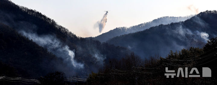 [경주=뉴시스] 이무열 기자 = 8일 오후 경북 경주시 문무대왕면 입천리에서 발생한 산불이 강풍을 타고 확산되는 가운데 소방헬기가 진화 작업을 벌이고 있다. 2026.02.08. lmy@newsis.com