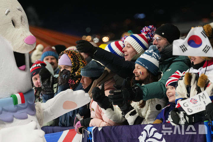 [리비뇨=AP/뉴시스] 9일(현지 시간) 이탈리아 리비뇨에서 열린 2026 밀라노·코르티나담페초 동계올림픽 여자 스노보드 빅에어 결승전에 앞서 올림픽 마스코트 '티나'가 관중들과 소통하고 있다. 2026.02.14.