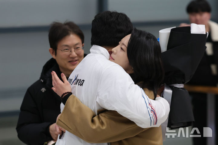 [인천공항=뉴시스] 권창회 기자 = 2026 밀라노-코르티나담페초 동계올림픽 스노보드 남자 평행대회에서 은메달을 차지한 김상겸이 10일 인천국제공항 제1여객터미널을 통해 귀국해 아내와 포옹하고 있다. 2026.02.10. kch0523@newsis.com