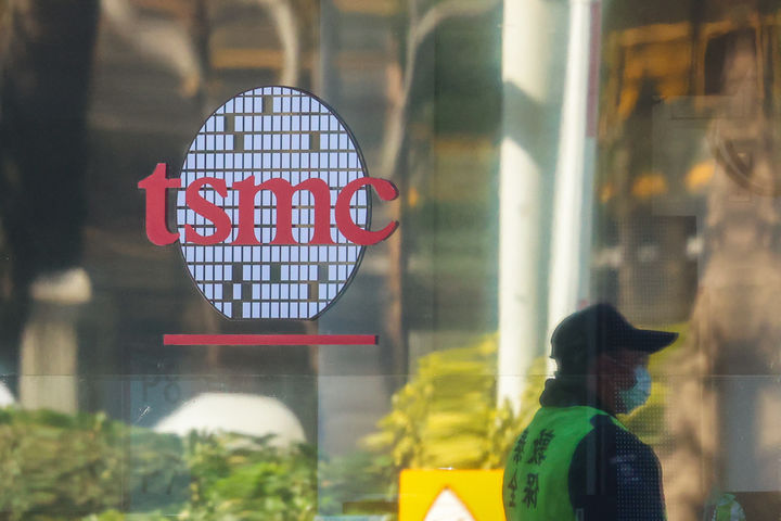 A security guard stands outside a building of TSMC or Taiwan Semiconductor Manufacturing Corp., a Taiwanese multinational semiconductor contract manufacturing and design company, in Hsinchu, Taiwan, on Thursday, Jan. 29, 2026. (AP Photo/Daniel Ceng)